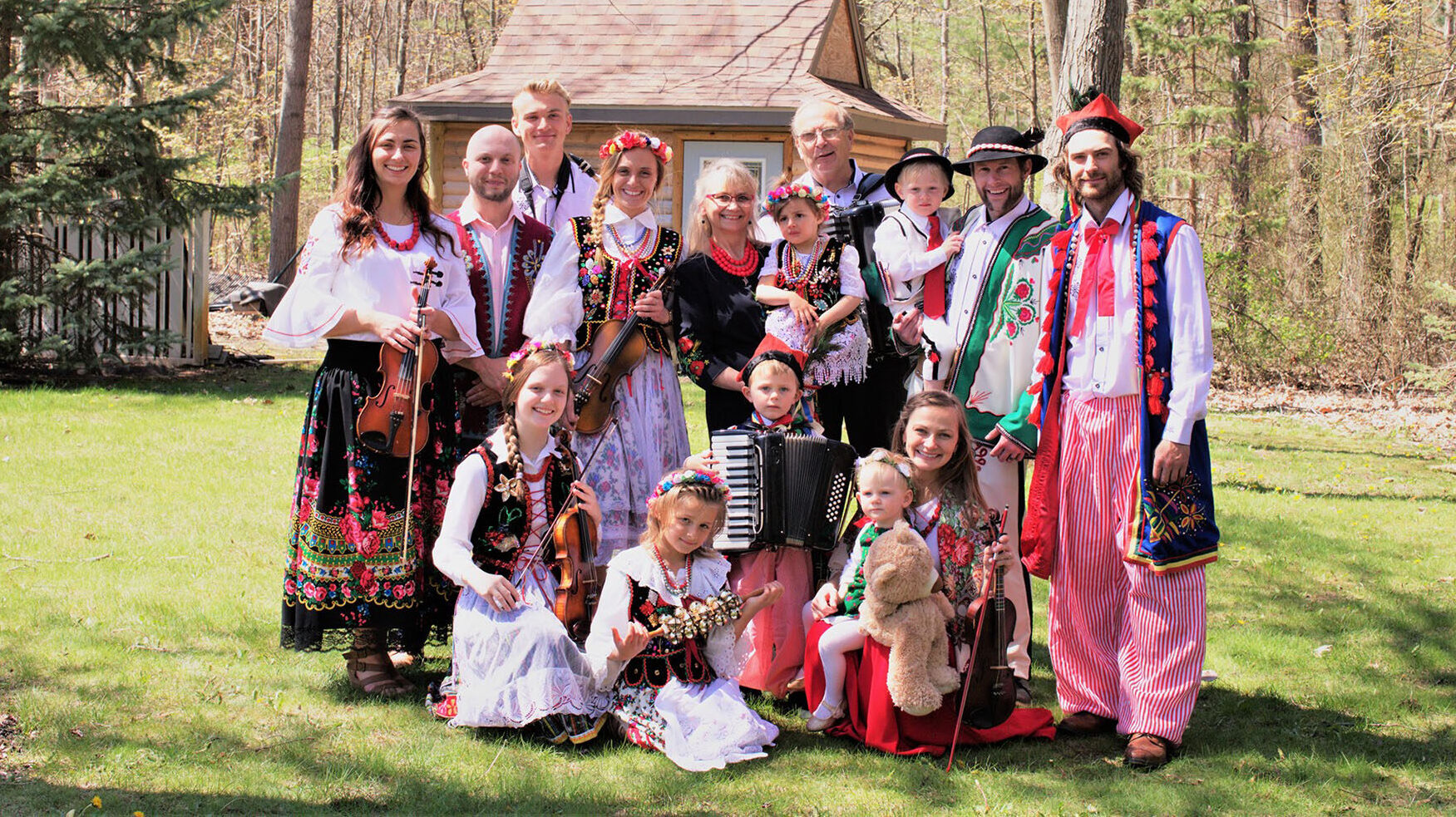Pan Franek Polka Band members in traditional polka outfits with scenic woods in background