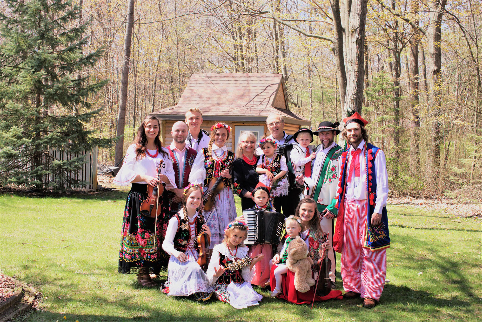 Pan Franek Polka Band members in traditional polka outfits with scenic woods in background
